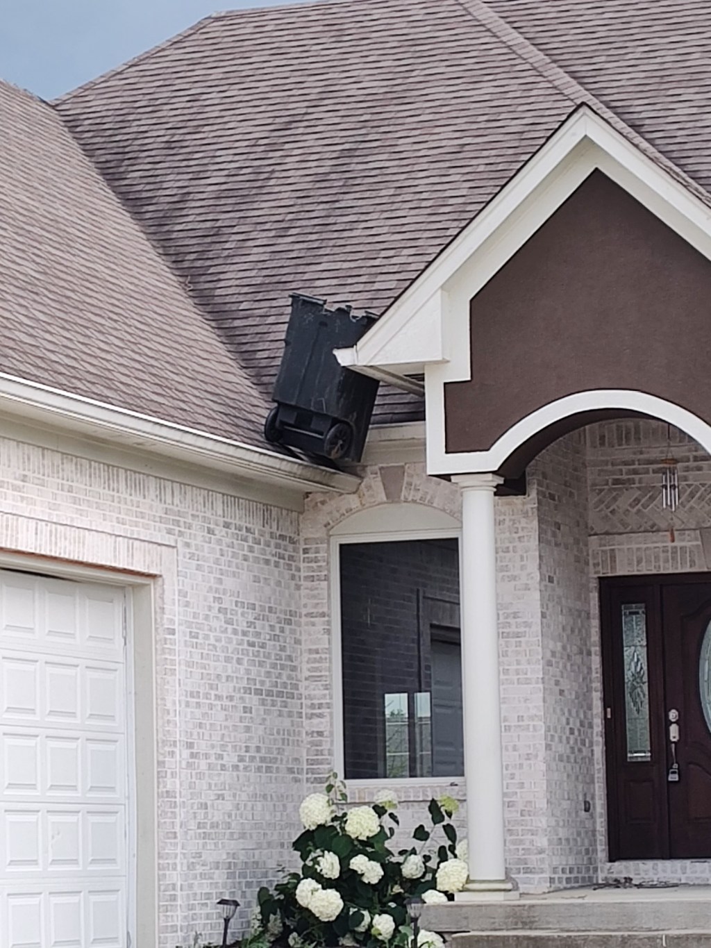 A picture of a trash can on top of a roof